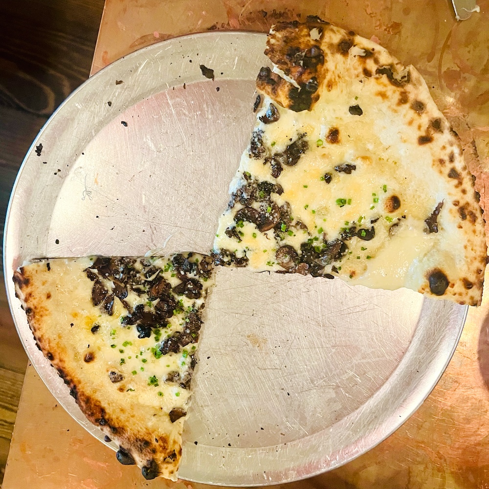 Aromatic mushroom pizza disappears quickly at lolita's pizzeria in poughkeepsei