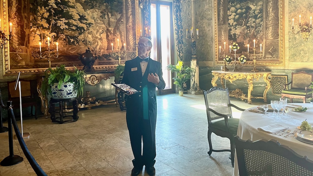 A docent in a butler's livery gives a tour of the mills mansion at staatsburg state park.