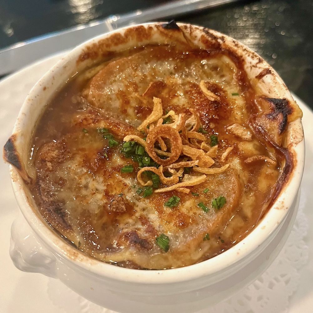 Willow, in rhinebeck, ny is an ideal lunch spot for a romantic getaway because you can share dishes like this brown and gooey french onion soup.