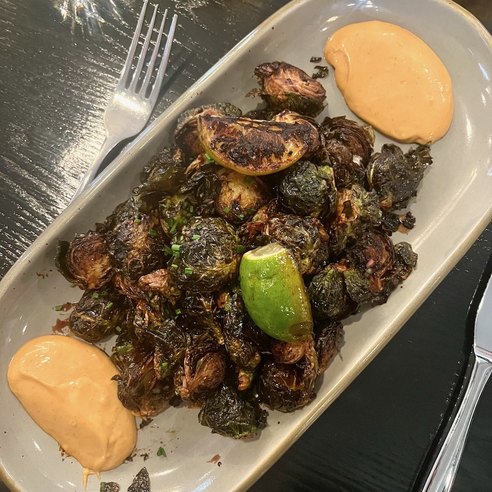 Charred brussels sprouts with chipotle mayo for dipping is a perfect side or appetizer to share at willow, the mirbeau inn's restaurant.