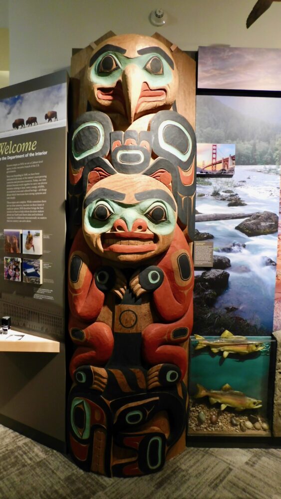 a native american carving greets visitors to the museum of the department of the interior.