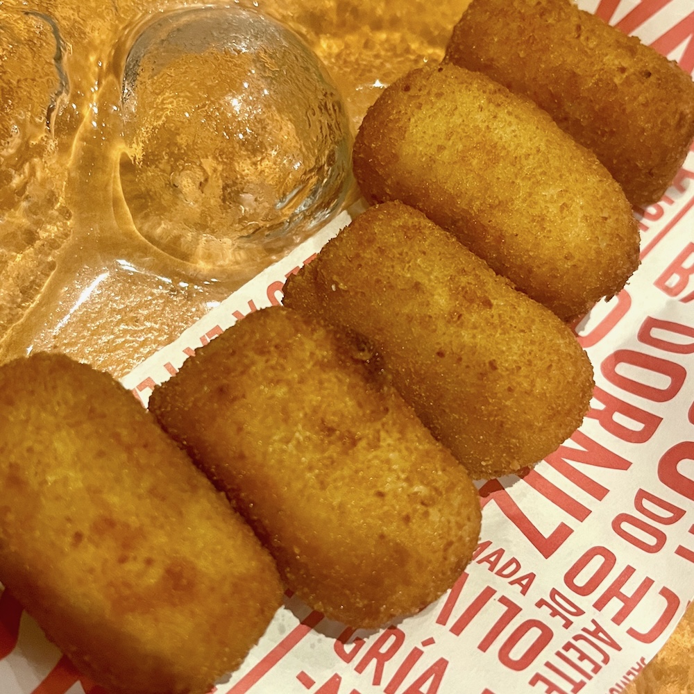 a golden, crunchy crust hides the creamy interior of jaleo's chicken croquetas.