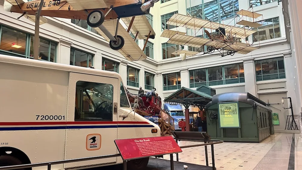 the u.s. postal museum's center space celebrates the trucks, trains, wagons and planes that have delivered mail over time