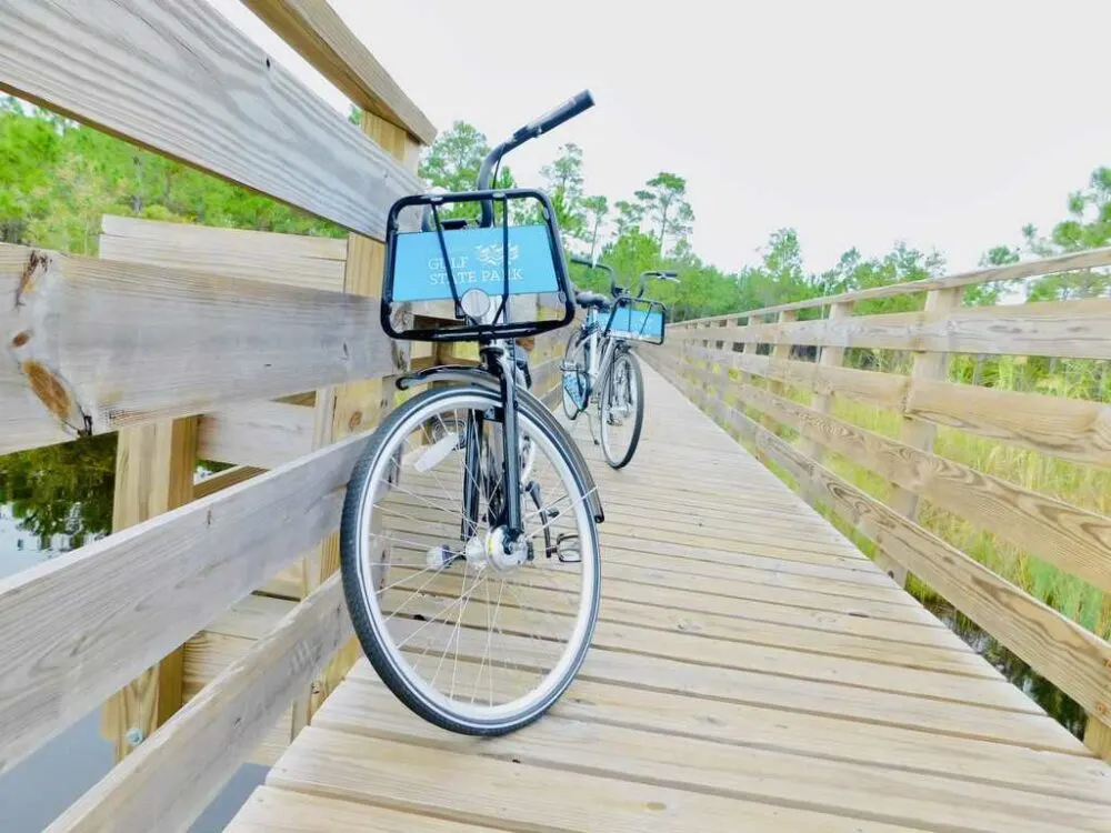 Free borrowed bikes on a wooden board walk in gulf shores state park