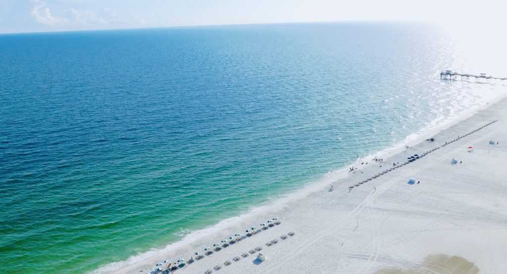 Gulf shores has a long stretch of beach with good sand and calm water.