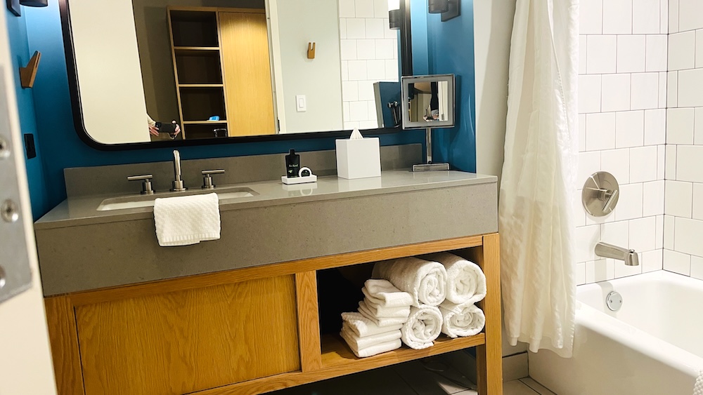 The bathrooms in the rooms at the lodge at gulf state park are modern with plenty of hooks and towels, plus a bathtub as well as a shower.