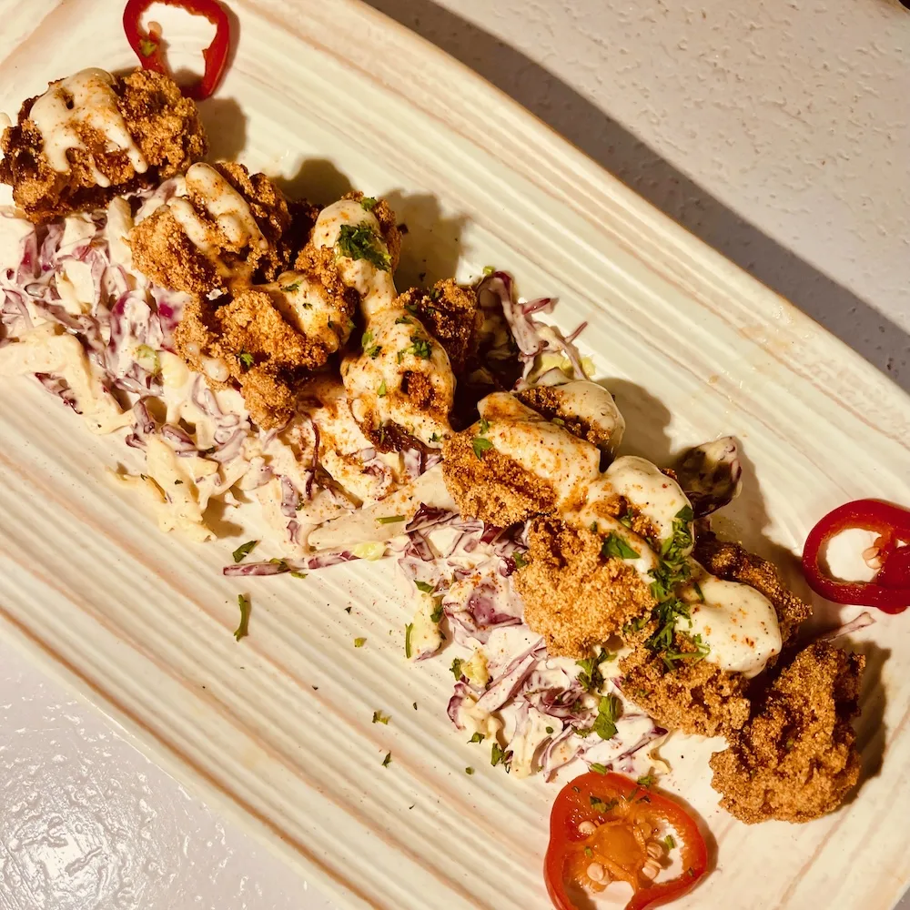 Fried oysters on a bed of crunchy cabbage slaw at zeke's restaurant on the alabama gulf coast.