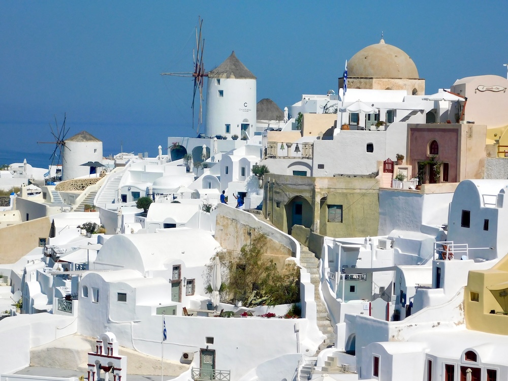 old and old-style windmills are a common sight on greek islands like santorini