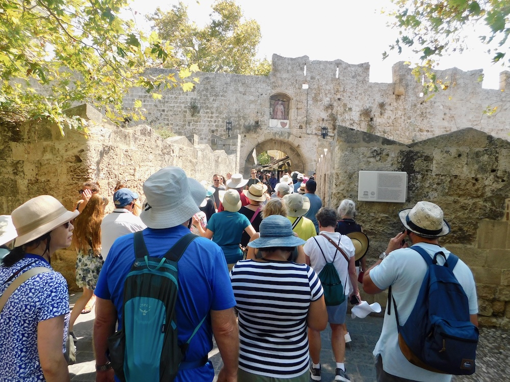 the wall medieval city in rhodes is popular with tourists and cruise-ship visitors. they can bottle neck at the busy town gates. 