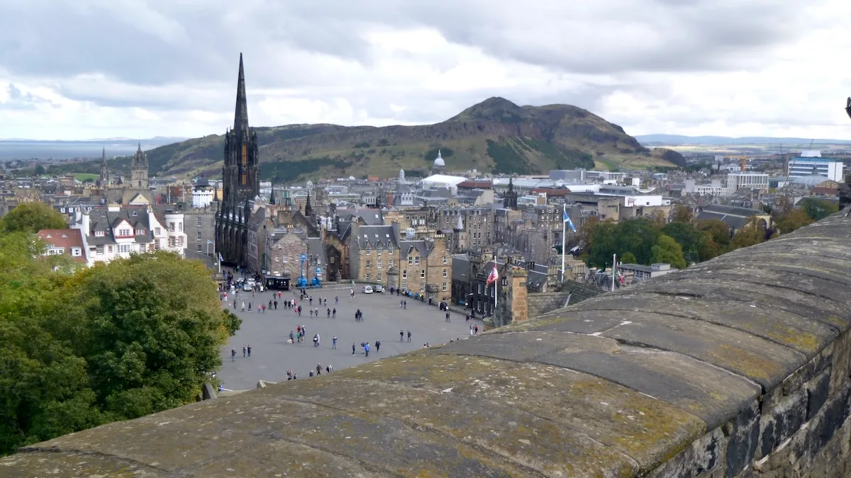 18 Stellar Things To Do, See & Eat in Edinburgh With Kids: A view of the rooftops of the city's Old Town and Arthur's Seat from Edinburgh Castle