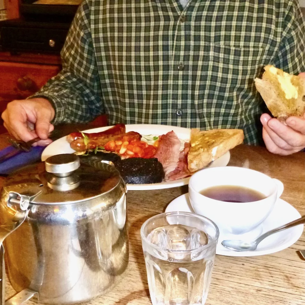 a man digs into the made-from-scratch full scottish breakfast at edinburgh larder.