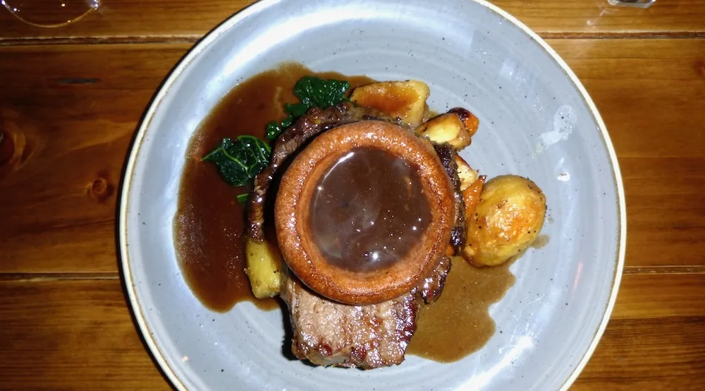 sunday roast is a meal kids and adults love equally. the ox pun serves it with a yorkshire pudding full of gravy. 