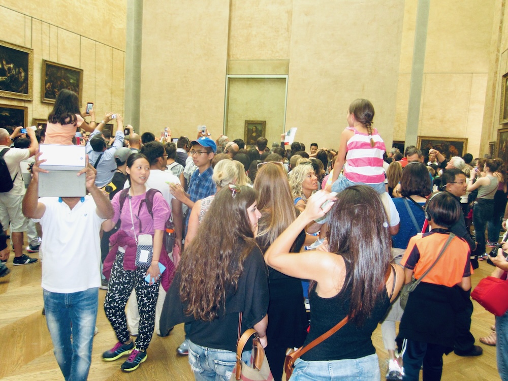 seeing the mona lisa up close can be difficult with kids because of the huge crowds.