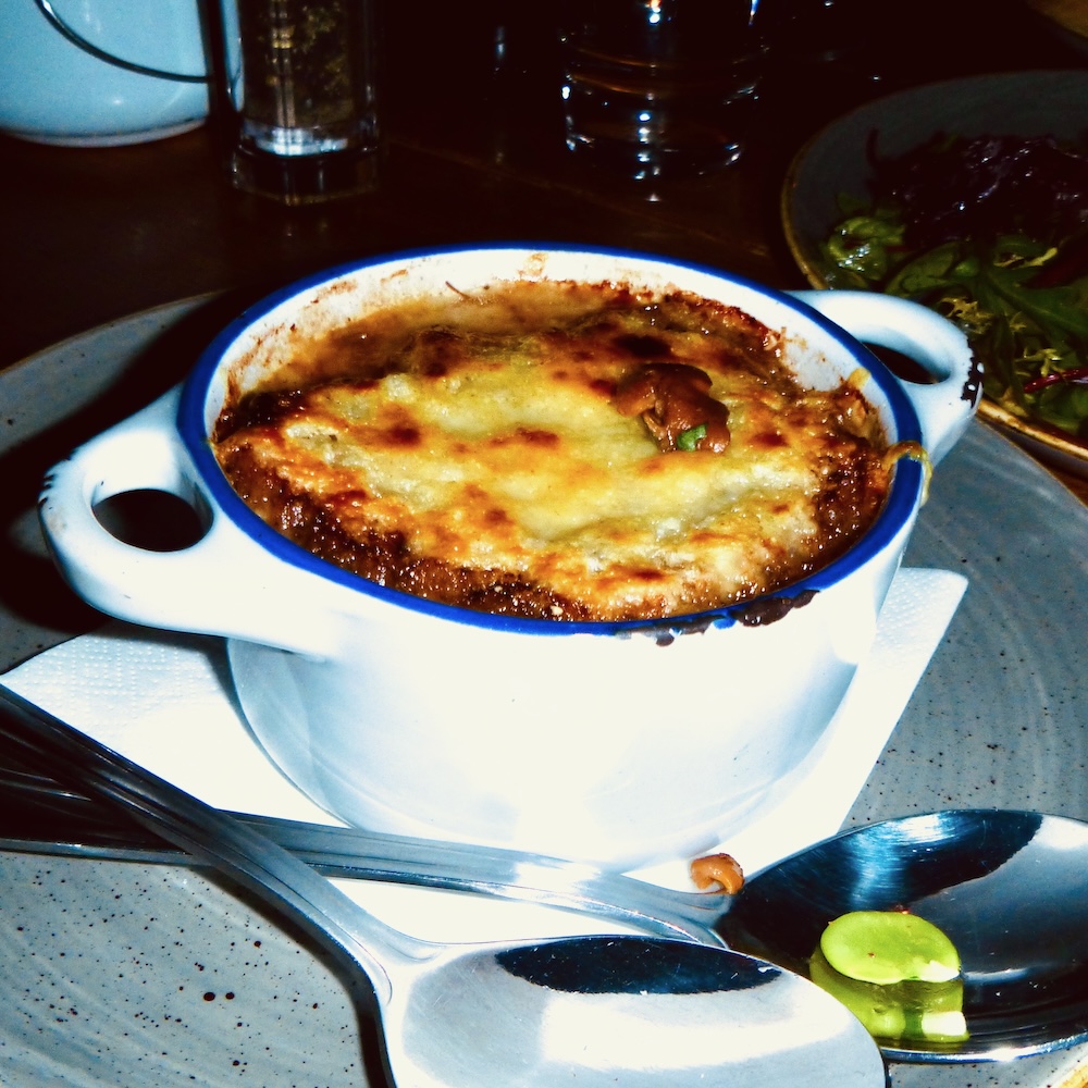 oxtail onion soup at the ox pub in the new town comes in a tiny dutch oven with gooey melted cheese.