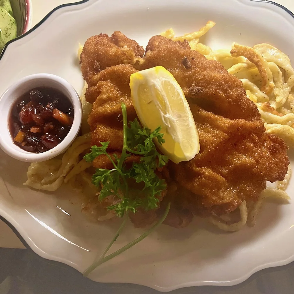 wiener schnitzel with spaetzle noodles and fresh berry compote at benelux in upstate ny.