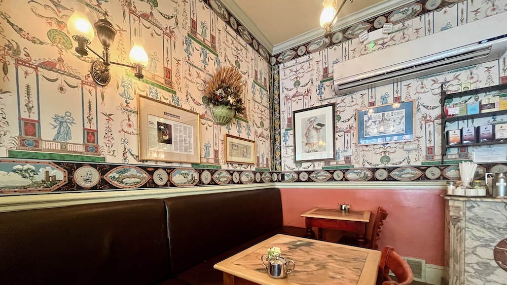 mrs. london's bakery has a victorian vibe thanks to colorful wallpaper and wooden furniture