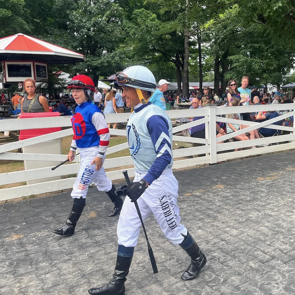 the lay-out of the saratoga race course lets you get an up-close look at the jockeys on their way to their races.